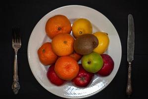 Ripe fruit on a white plate photo