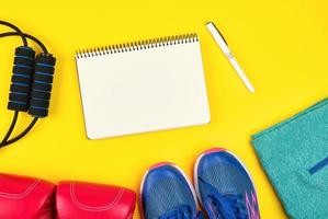 open empty notebook and sports women's clothing for sports and fitness photo