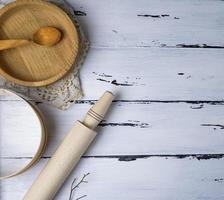 wooden round plates, sieve and rolling pin photo