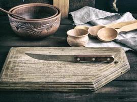 old wooden cutting board and knife photo