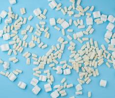 scattered white foam for packaging parcels on a blue background photo