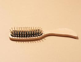 wooden hair comb on brown background, zero waste. photo