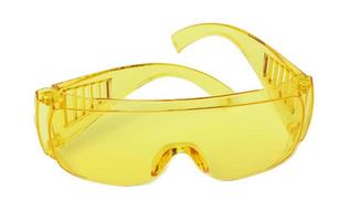 Yellow plastic protective goggles for workers on a white isolated background photo