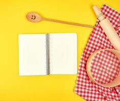 blank open notebook and wooden kitchen accessories photo