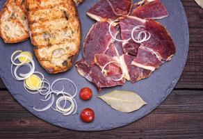 pieces of jamon and white fried bread photo