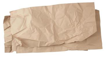 crumpled brown sheet of paper for packaging goods isolated on white background photo