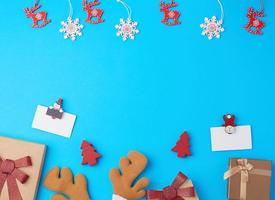 closed square gift boxes with bows on a blue background photo