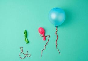 blue inflated and deflated rubber balls and red rope photo