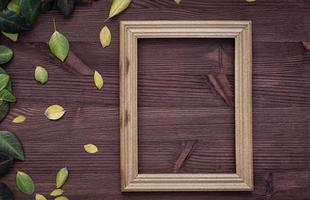 Empty wooden frame on brown wood surface photo