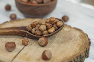 Shelled nuts, hazelnuts in a wooden spoon photo