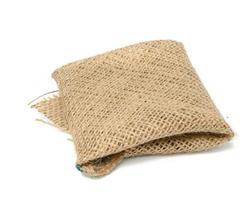 folded brown burlap fabric and ioled on white background photo