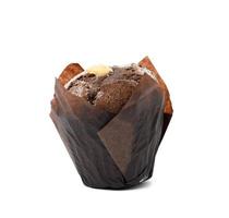 baked chocolate muffis with cream wrapped in brown paper photo