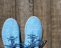 pair of blue textile shoes, top view photo