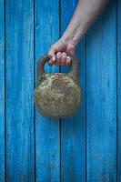 Iron kettlebell in the hand of man photo