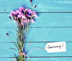 bouquet of pink carnations and a paper tag photo