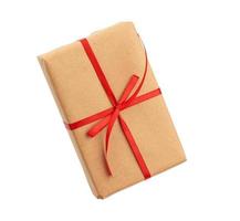 rectangular box wrapped in brown paper and tied with a red bow, gift isolated on white background photo