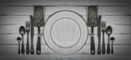 Vintage cutlery on a white wooden surface photo