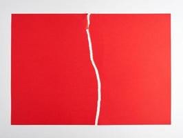 torn in half empty red sheet of paper on white background photo