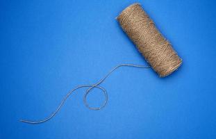 whole coil of twisted brown rope jute tourniquet, eco-friendly packaging photo