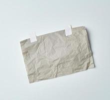 gray crumpled sheet of paper glued with white adhesive tape photo