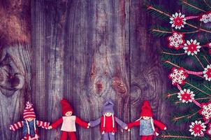 Vintage wooden Christmas background with rag dolls photo
