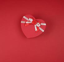 red gift box in the form of a heart with a bow photo