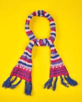 knitted scarf of multicolored wool threads tied in a knot photo