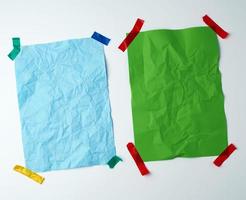 two blank crumpled sheets of paper glued with rubber colored adhesive tape photo