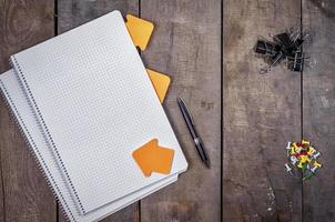 Open empty notebook on a brown wooden surface photo