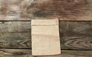 empty canvas gray bag on a wooden background from boards photo