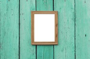 wooden frame hanging on the green old wooden cracked wall photo