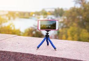 smart phone stands on a tripod photo