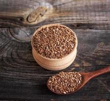 flax seeds in a wooden bowl and spoon photo