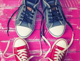 Two pairs of textile sneakers with loose laces photo