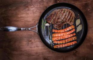 fried piece of beef on a round frying pan photo