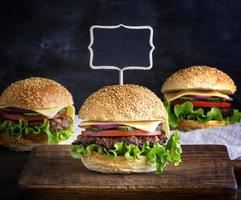 large hamburger with a meatball and vegetables photo