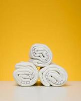 Twisted white rags for mopping on a yellow background photo