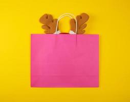 pink paper bags for shopping, inside the Christmas mask of a deer photo