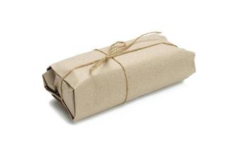 Embalaje de rollo de papel atado con cuerda marrón y aislado sobre fondo blanco. foto