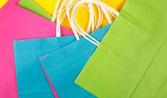 many multi-colored paper shopping bags with white handles photo