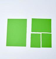 various blank pieces of green paper on white background, copy space photo