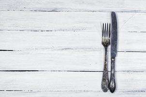white wooden background with cutlery photo
