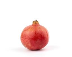 ripe red pomegranate in a peel on a white background photo