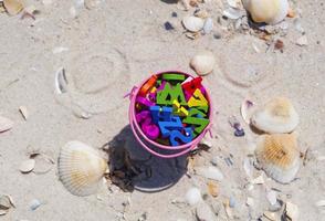 bucket full of wooden multicolored letters photo