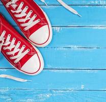 pair of red textile sneakers with white laces photo