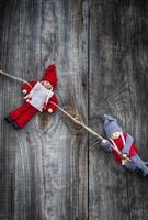 two little rag dolls hanging from a rope photo