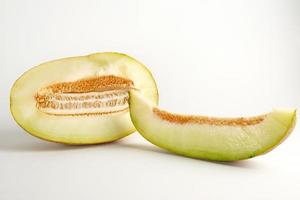 piece of ripe melon with seeds on a white background photo