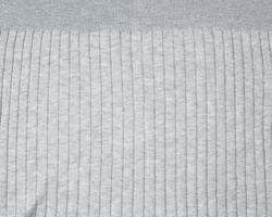 fragment of gray knitted fabric, full frame, fabric for sweaters photo