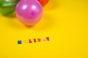 Abstract yellow background with holiday sign and balloons photo