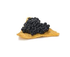 triangular nachos with black paddlefish caviar isolated on white background. Snack photo